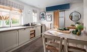 Greengate - kitchen with dining space for four guests and door leading to utility room