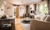 The Old Paper Mill - bright and cosy sitting room with three seater sofa and loveseat