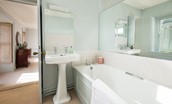 Honeystone House - en suite of bedroom six with large bath and full width mirror