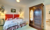 The Eslington Lodge - bedroom two with twin beds, wardrobe and en-suite