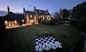 Brockmill Farmhouse - beautiful, welcoming house at dusk with garden games on lawn