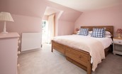 The White House - bedroom three with double bed, chest of drawers and garden views