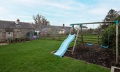 Moo House - play area with swings and slide to keep children entertained in the garden