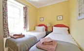 Fordel Cottage - bedroom two with twin beds and large window with views of the fields